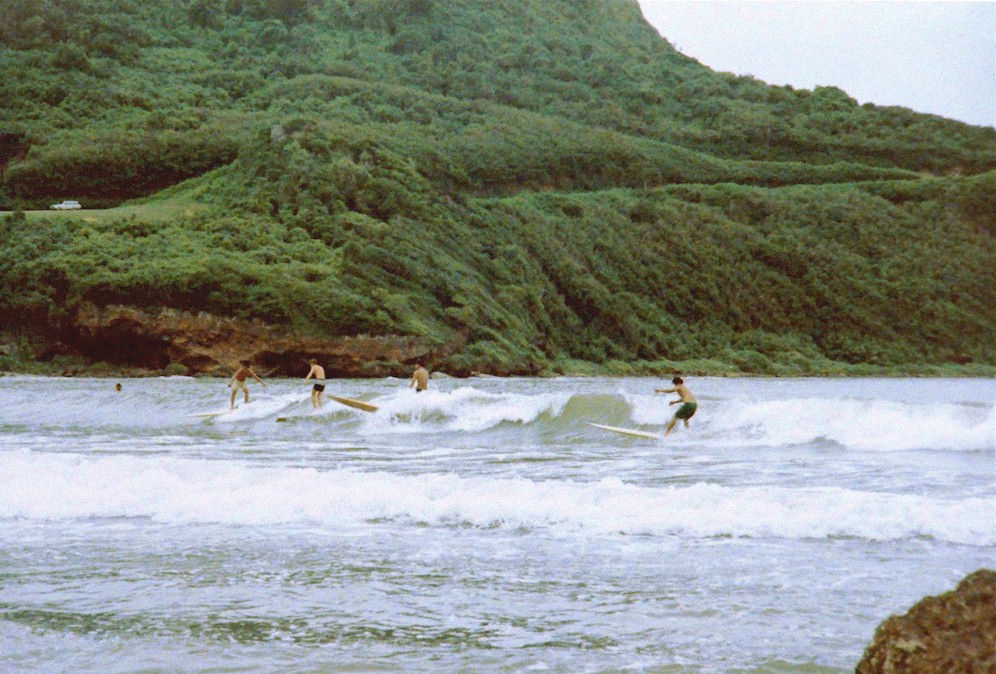 Four surfers at Talofofo Bay, Guam.